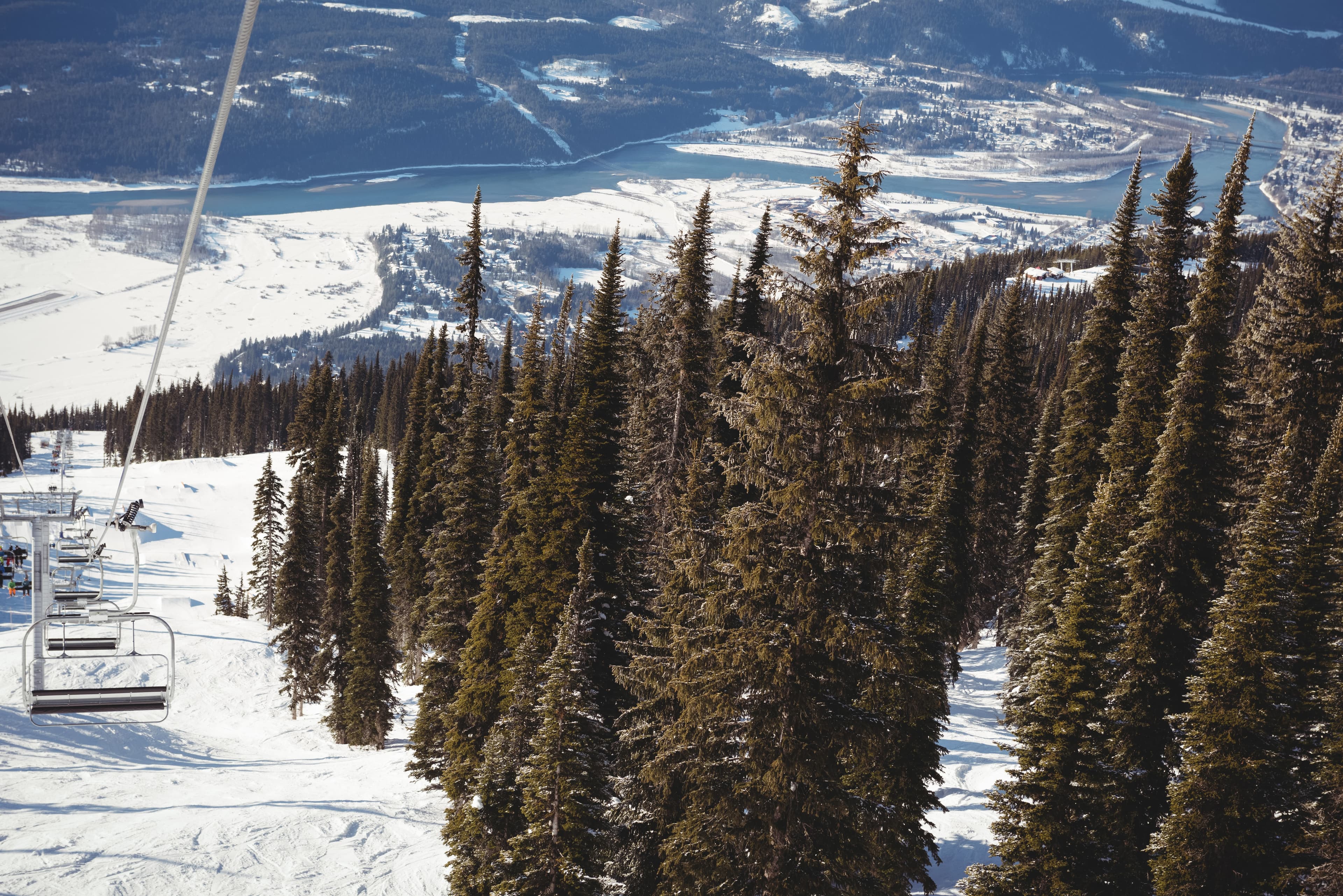 Ski lift and pine trees overlooking a Vermont valley in winter